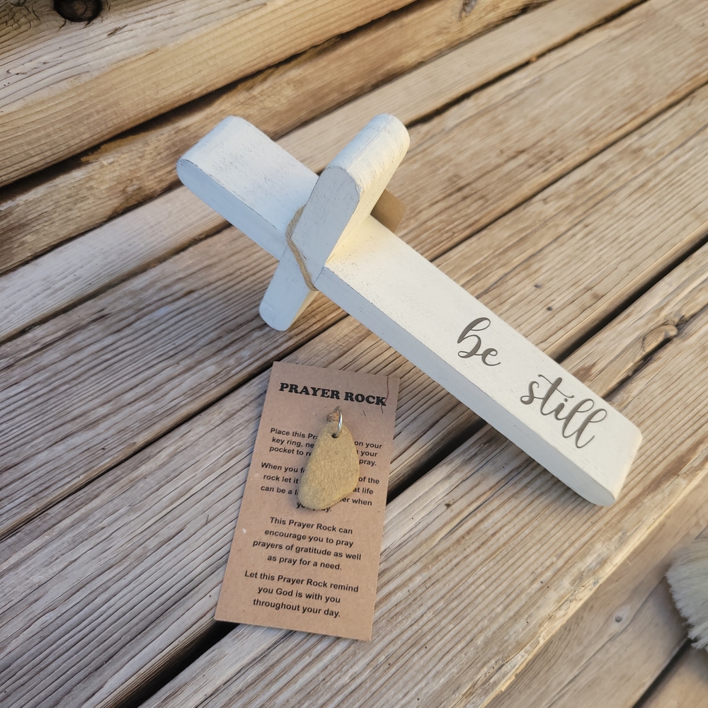 White Wooden Cross with 'Be Still' Inscription